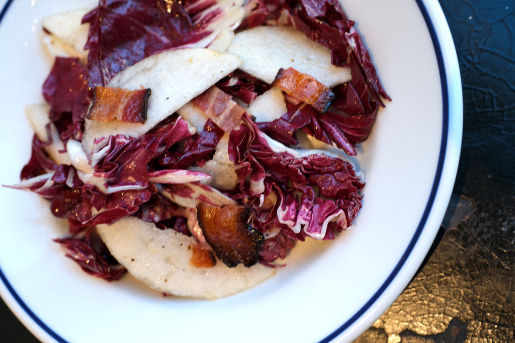 Radicchio and asian pear salad on white plate